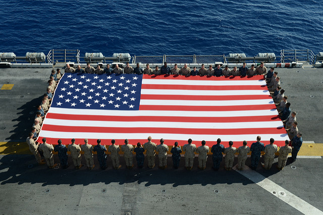 Sailors holding flag